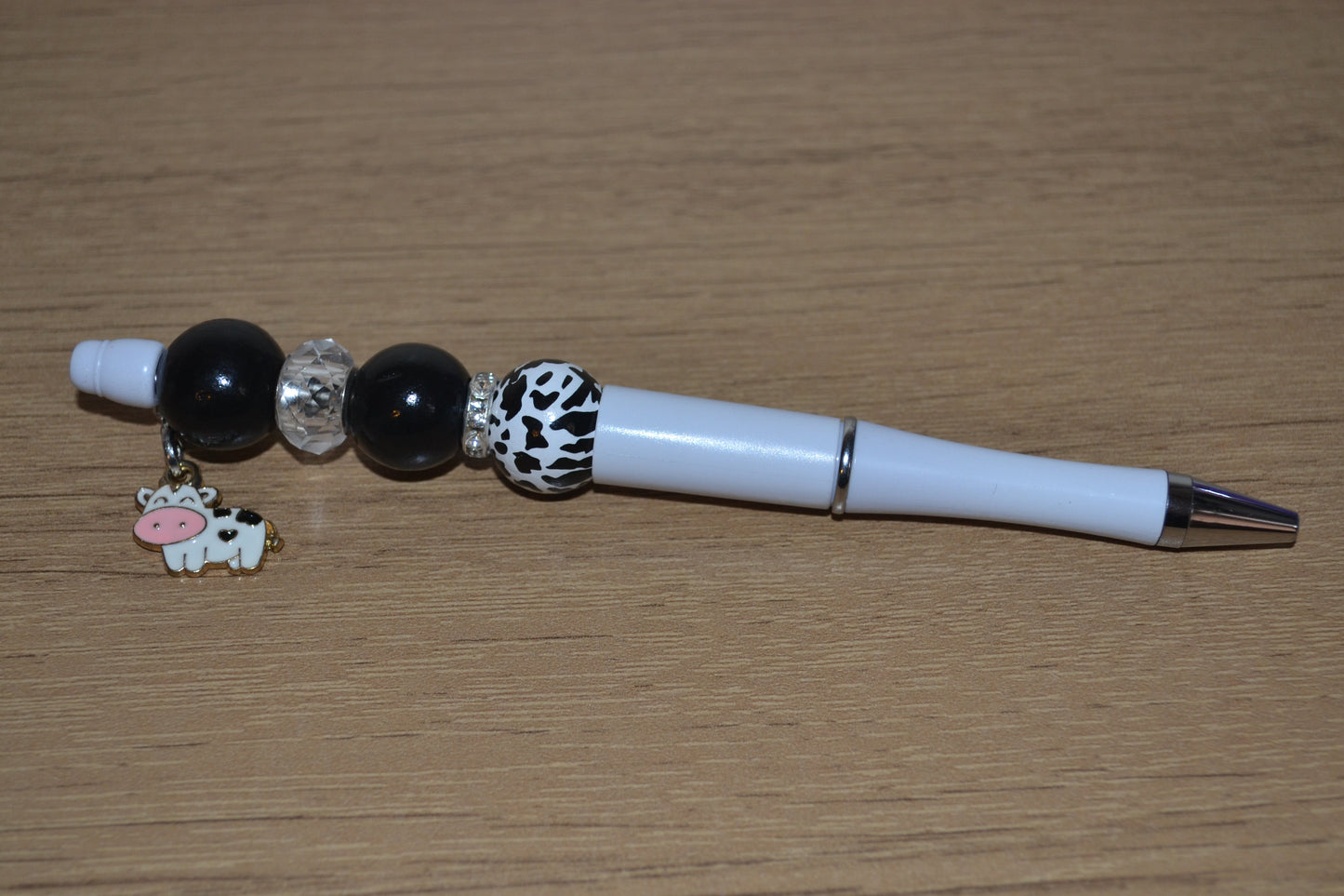 Beaded pen with hanging cow pendant
