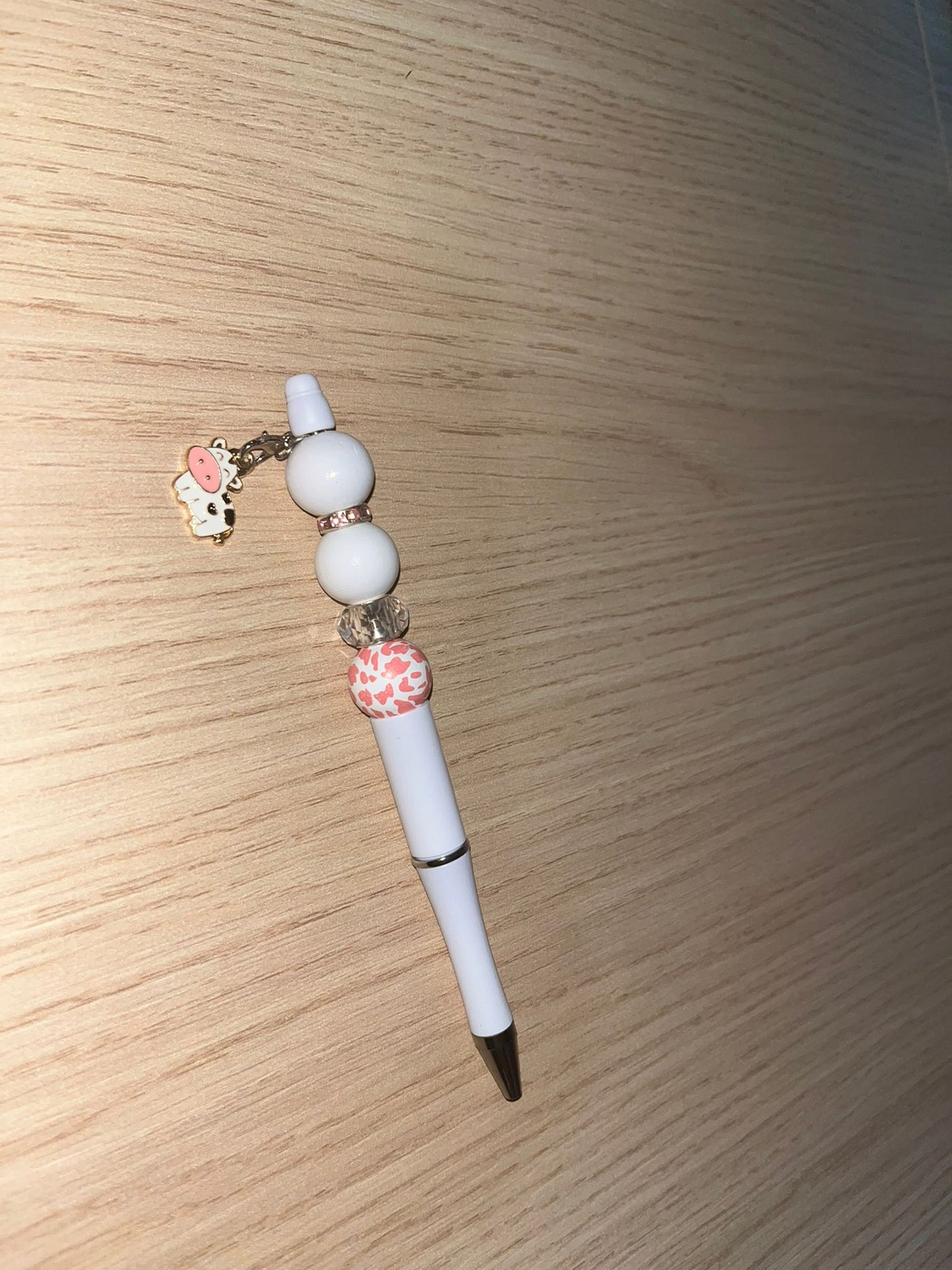 Beaded pen with hanging cow pendant