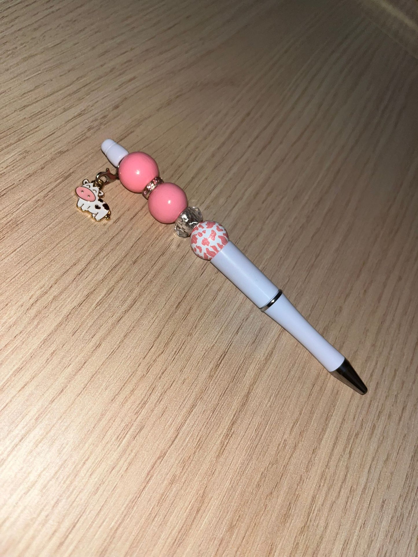 Beaded pen with hanging cow pendant