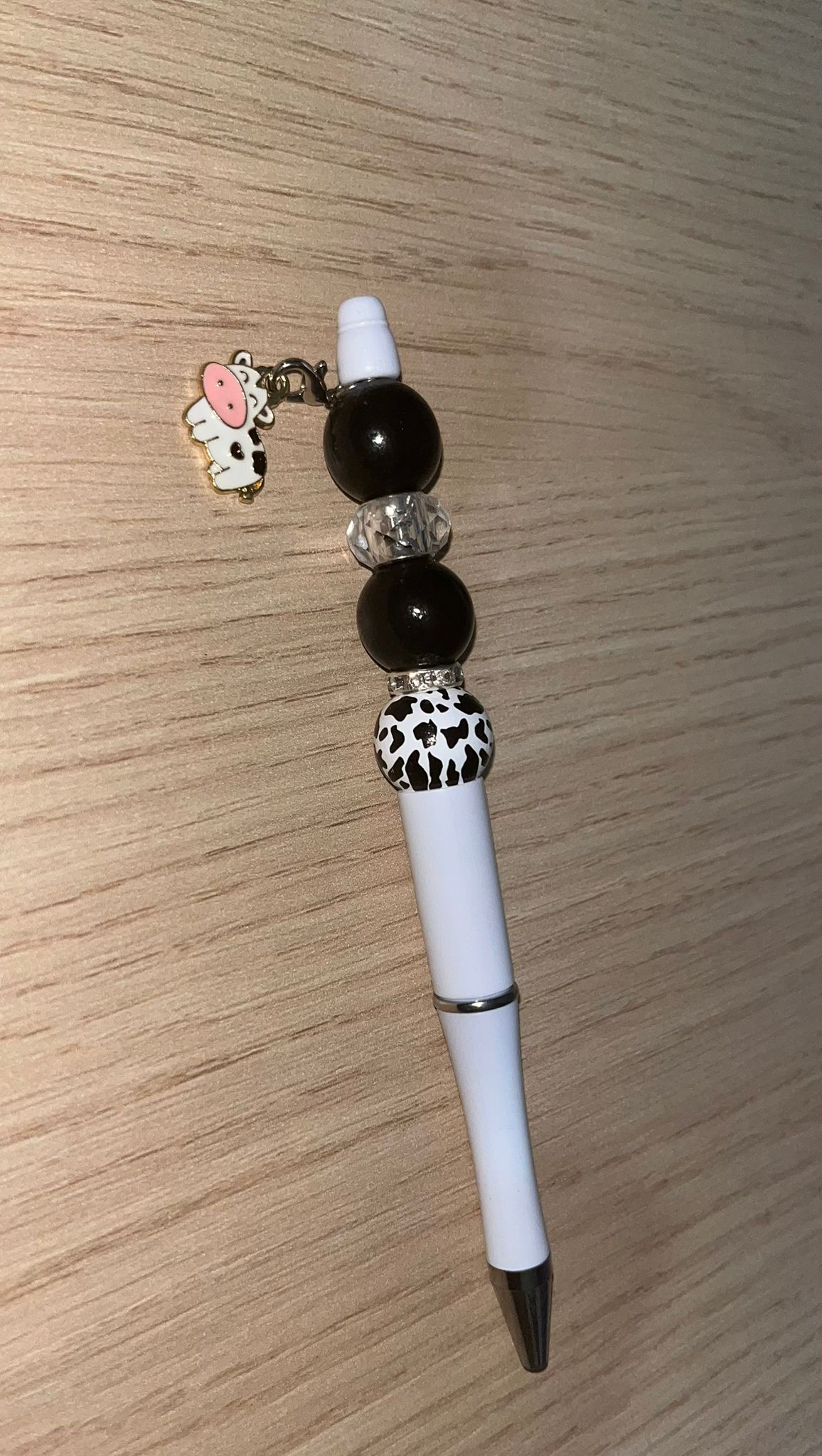 Beaded pen with hanging cow pendant