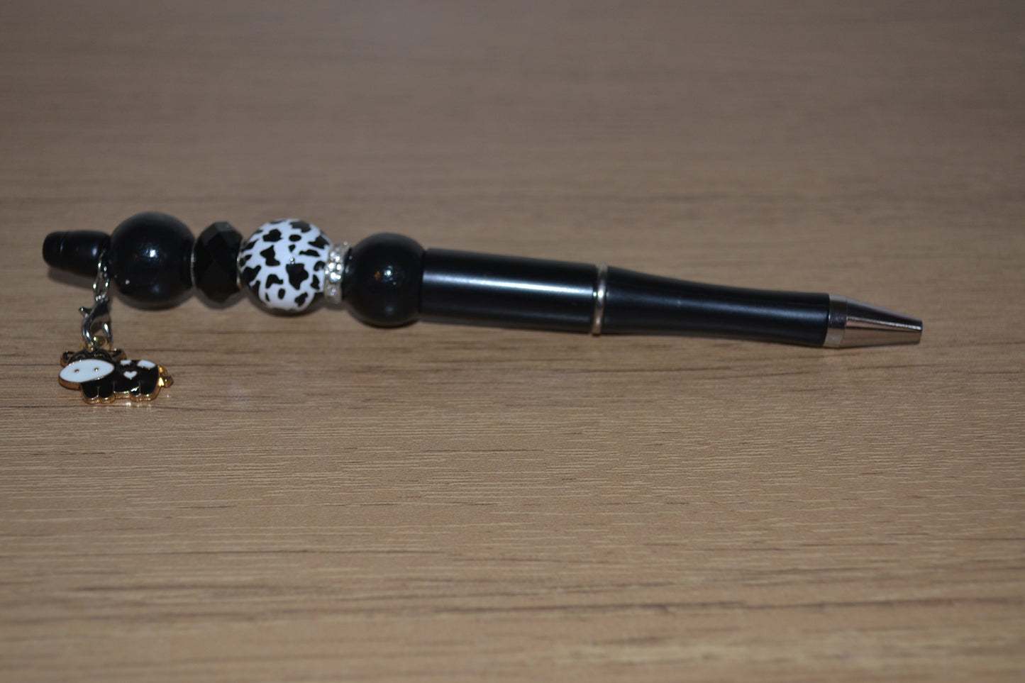Beaded pen with hanging cow pendant