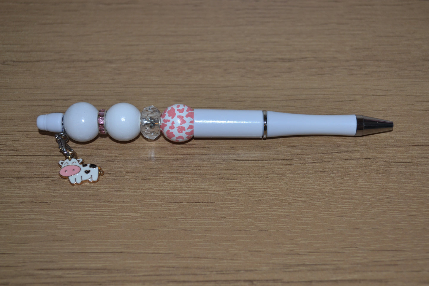 Beaded pen with hanging cow pendant