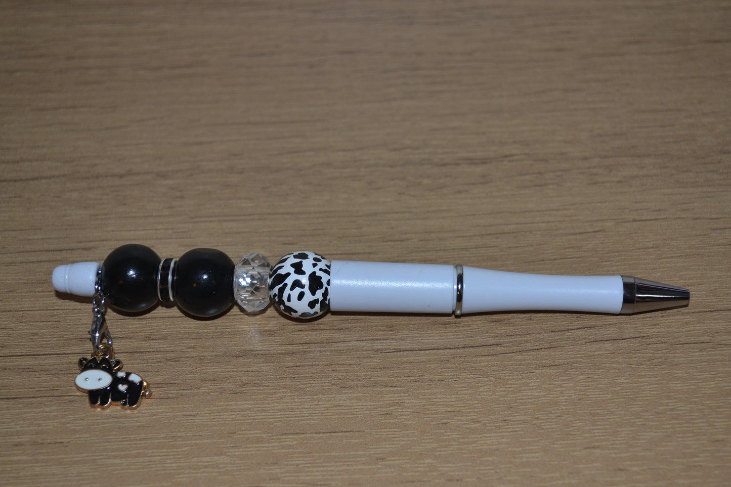 Beaded pen with hanging cow pendant