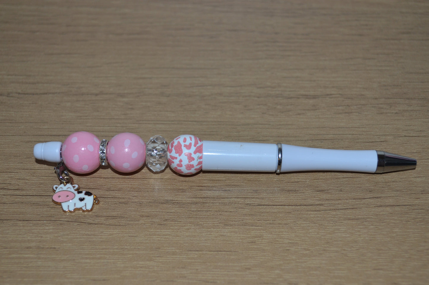 Beaded pen with hanging cow pendant
