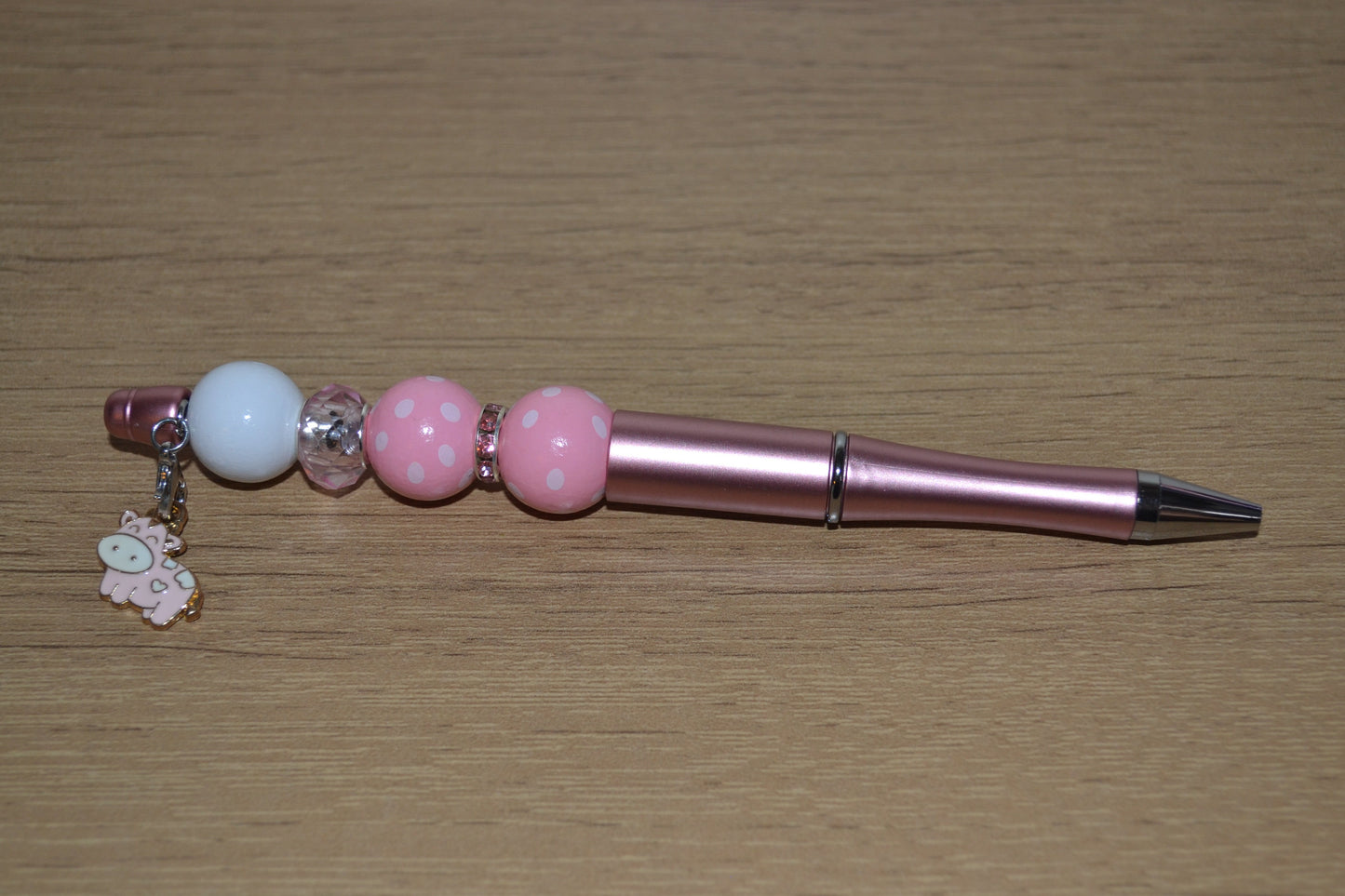 Beaded pen with hanging cow pendant