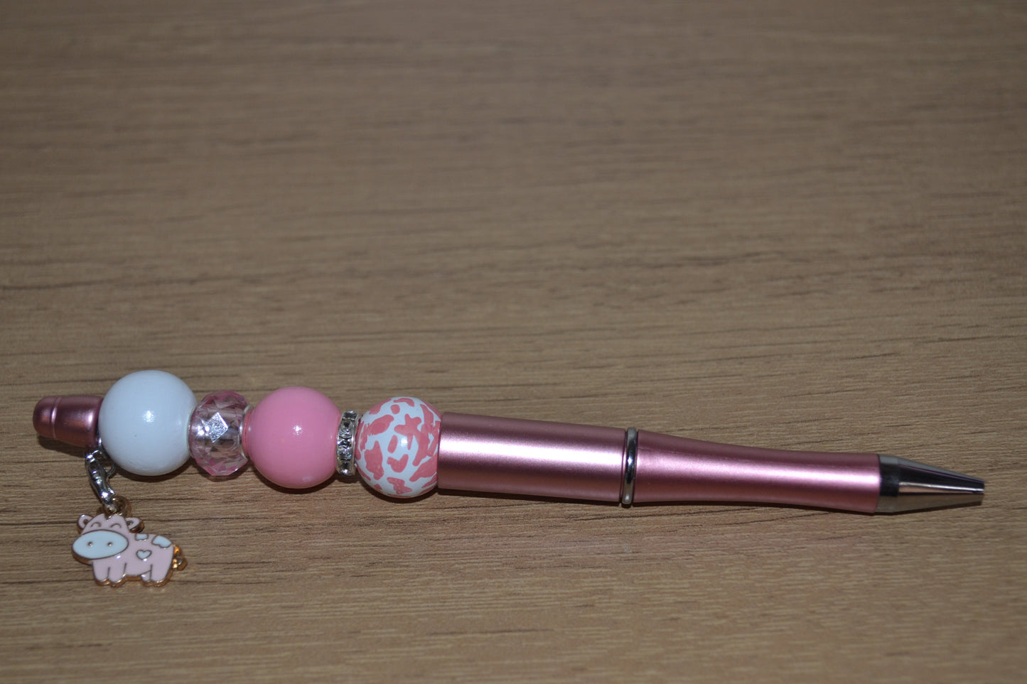 Beaded pen with hanging cow pendant
