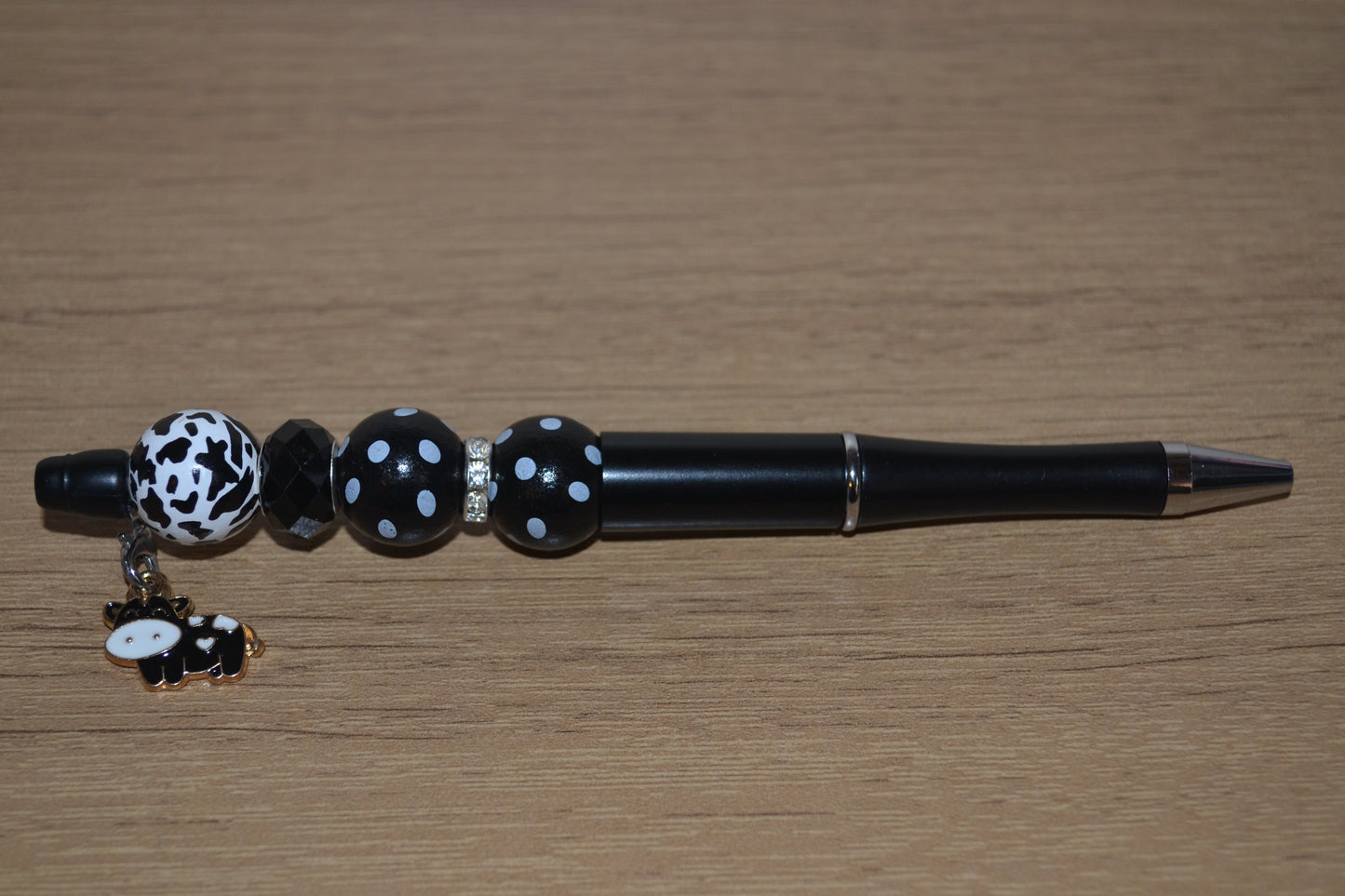 Beaded pen with hanging cow pendant