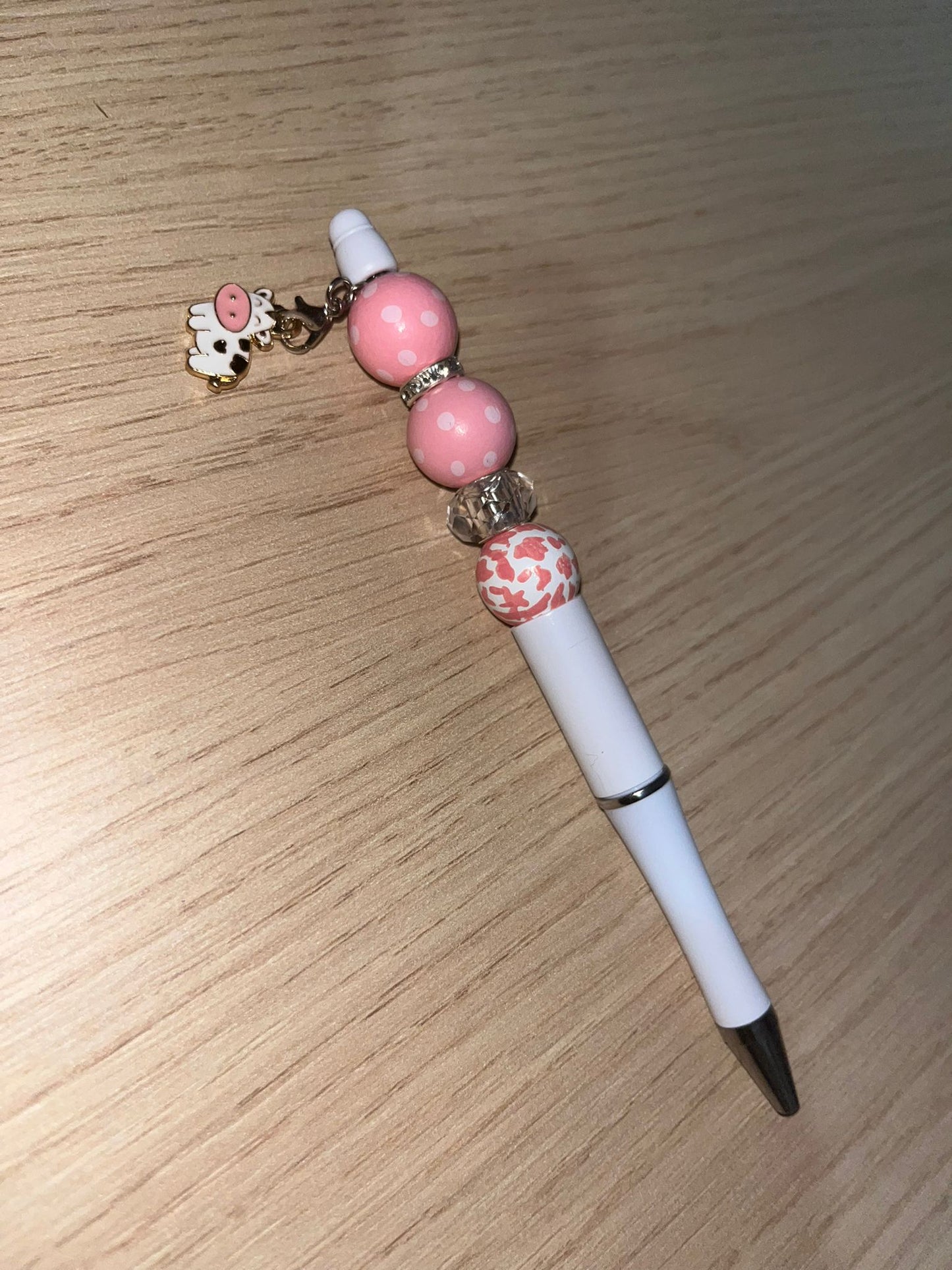 Beaded pen with hanging cow pendant