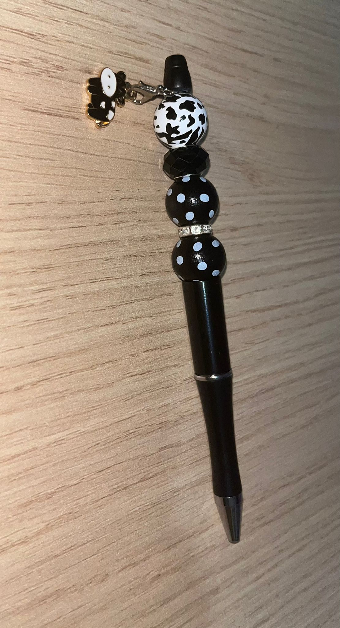 Beaded pen with hanging cow pendant