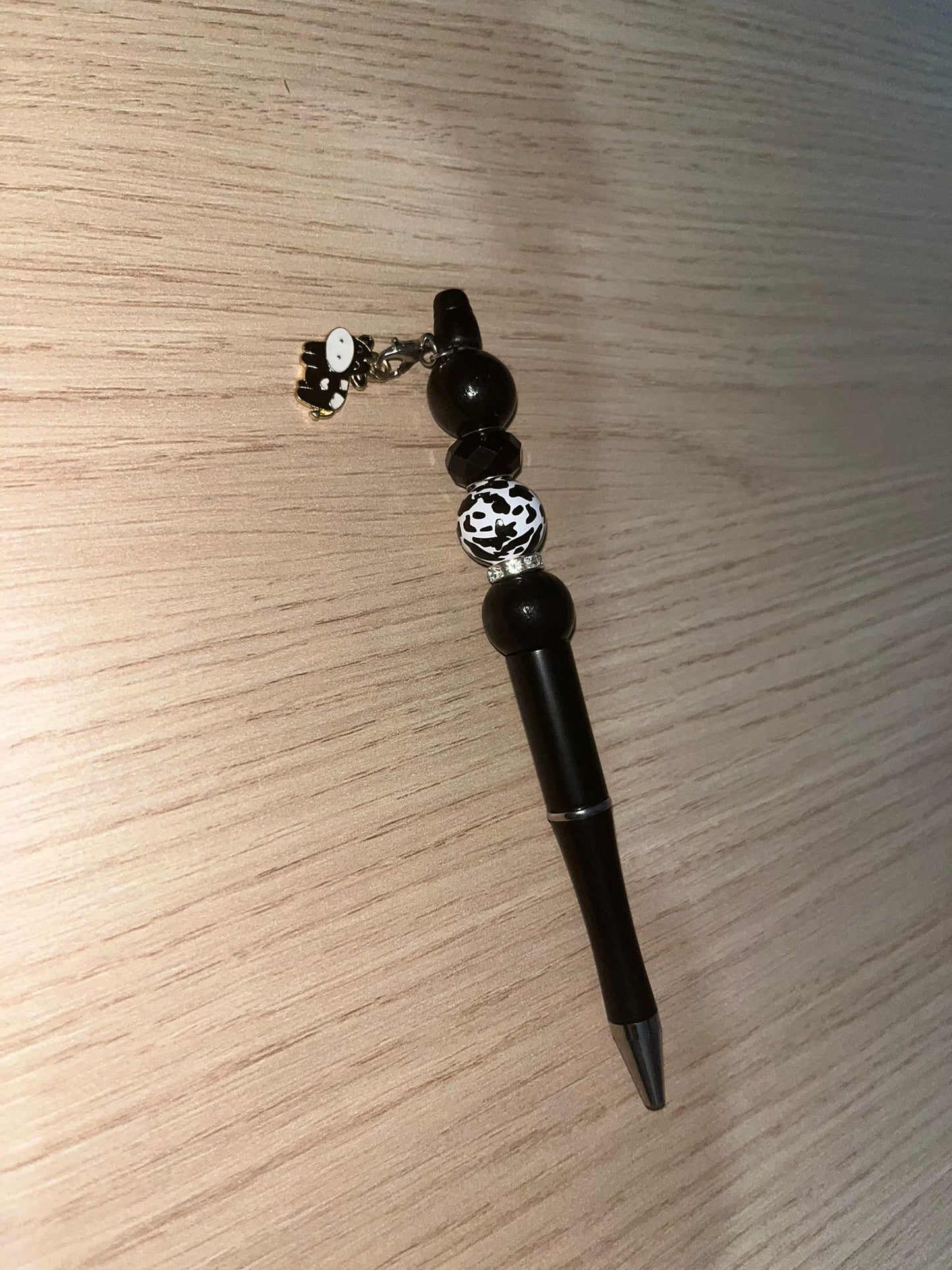 Beaded pen with hanging cow pendant
