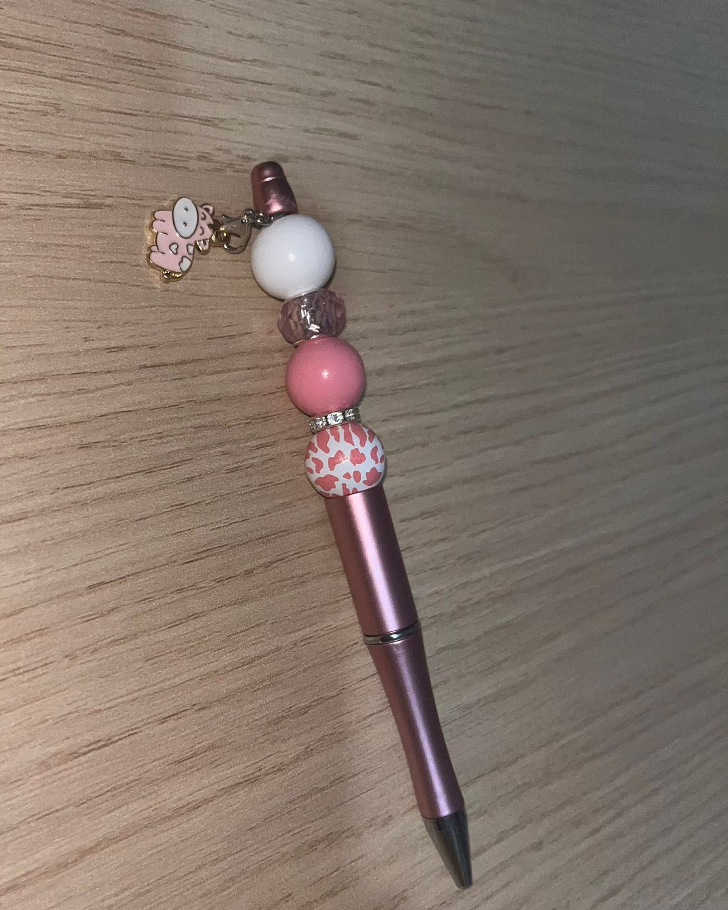 Beaded pen with hanging cow pendant